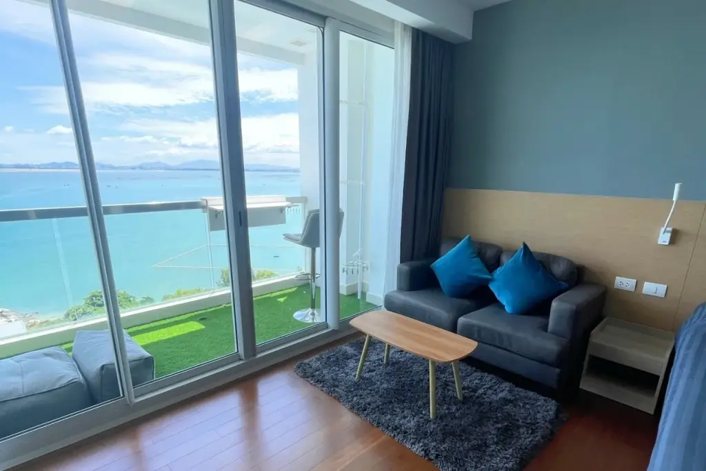 1 Bedroom Condo for Sale at Palm Wongamat living room with sofa and TV