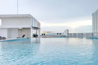 C View Residence 2 bedroom with large window showing ocean glimpse and Pattaya skyline view