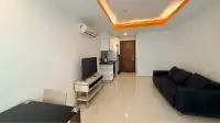 1 Bedroom Condo for Rent at C View Residence Pattaya living area view toward entrance door, TV stand and dining table