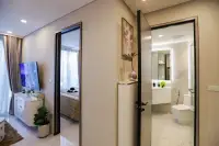 1 Bedroom Condo for Sale at Copacabana Coral Reef hallway view showing bedroom entrance and modern marble bathroom with LED mirror