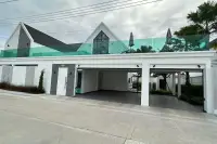 3 Bedroom House for Sale at Larelana Villa front view with carport, modern architecture, and rooftop terrace.