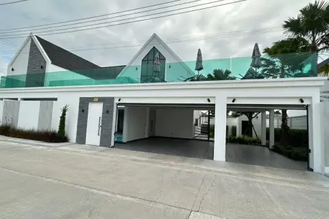 3 Bedroom House for Sale at Larelana Villa front view with carport, modern architecture, and rooftop terrace.