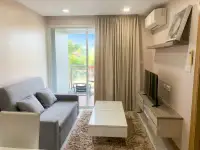 1 Bedroom Condo for Sale at Whale Marina living room with gray sofa, TV unit and balcony access