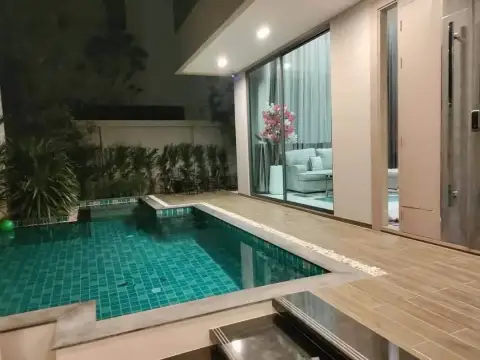 5 Bedroom House for Rent at Casa Jomtien private outdoor pool and wooden deck lit up at night