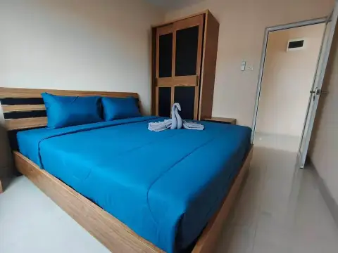 2 Bedroom Condo for Rent at CC Condominium 2 bedroom with blue bedding, wooden wardrobe and tiled flooring