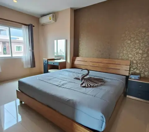 2 Bedroom Condo for Rent at CC Condominium 2 master bedroom with wooden headboard, towel swan decor and dressing table