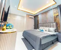 4 Bedroom House for Sale in Central Pattaya primary bedroom with upholstered headboard and wardrobe