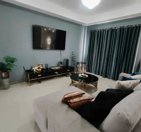 3 Bedroom House for Rent at Central Park 4 living area with teal curtains, black coffee table, and TV console