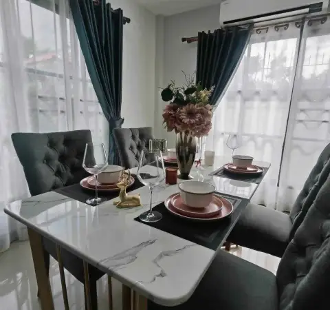 3 Bedroom House for Rent at Central Park 4 dining table with marble top set with plates, wine glasses, and flowers