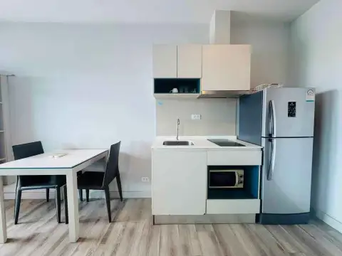 1 Bedroom Condo for Sale at Centric Sea compact kitchen with fridge, microwave, and dining table