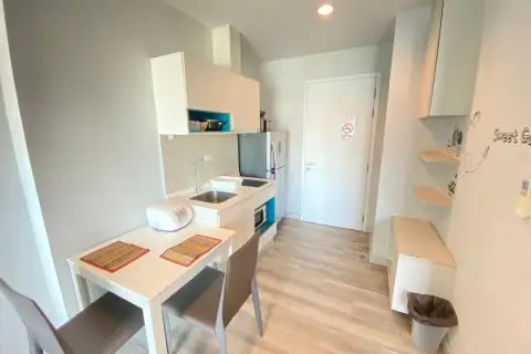 1 Bedroom Condo for Rent at Centric Sea compact kitchenette with sink, dining table, and entrance door