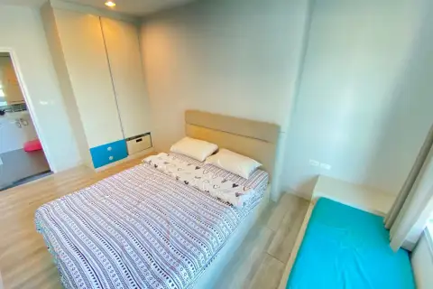 1 Bedroom Condo for Rent at Centric Sea bedroom with patterned bedspread, wardrobe, and attached bathroom