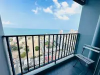 1 Bedroom Condo for Rent at Centric Sea private balcony with sea view, city skyline, and folding chair