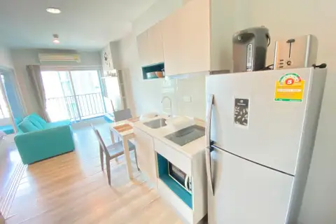 1 Bedroom Condo for Rent at Centric Sea kitchen with refrigerator, stovetop, and open view to living area