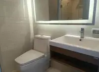 1 Bedroom Condo for Sale at Cetus Beachfront bathroom with toilet, vanity sink and backlit mirror