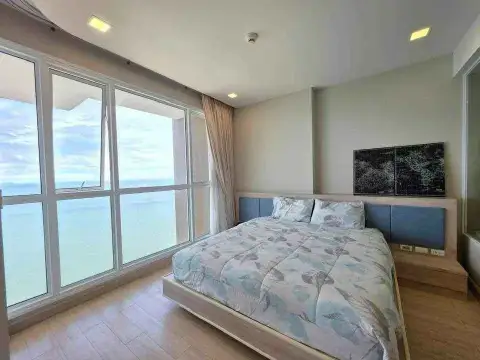 1 Bedroom Condo for Rent at Cetus Beachfront bedroom with king bed and floor-to-ceiling ocean view windows