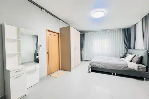 2 Bedroom House for Rent in Chak Nok bedroom with wardrobe, vanity mirror, and wooden entry door