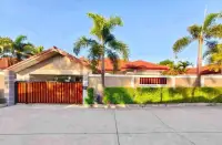 3 Bedroom House for Rent in Chak Nok exterior view with wooden gate and palm-lined driveway