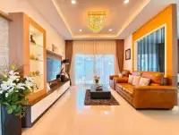 3 Bedroom House for Rent in Chak Nok living room with leather sofas and crystal chandelier