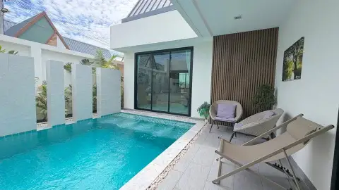 3 Bedroom House for Rent in Chak Nok outdoor swimming pool with wicker chairs and wooden accent wall