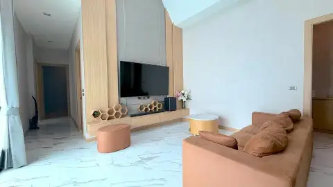 3 Bedroom House for Rent in Chak Nok living room with wall-mounted TV and orange sofa