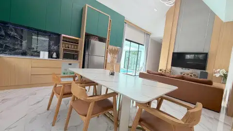 3 Bedroom House for Rent in Chak Nok open-plan dining area with marble table and pool view