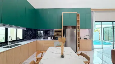 3 Bedroom House for Rent in Chak Nok modern kitchen with green cabinetry and marble backsplash
