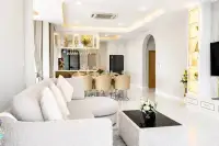 4 Bedroom House for Sale at Chokchai Garden Home 2, dining area with a white marble table, six chairs, and large windows.