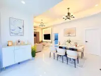 3 Bedroom House for Sale at Chokchai Village 5 open-plan living and dining area with white decor and chandelier