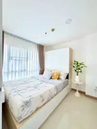 1 Bedroom Condo for Sale at City Center Residence bedroom with floral bedding and built-in wardrobe headboard