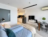 1 Bedroom Condo for Rent at City Center Residence open-plan bedroom with kitchenette and dining table