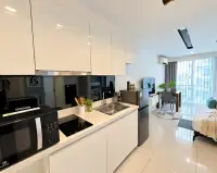 1 Bedroom Condo for Rent at City Center Residence white kitchenette with sink, stove and living area view