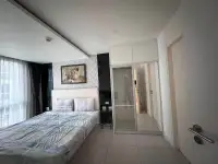 1 Bedroom Condo for Sale at City Center Residence bedroom with lion wall art and mirrored wardrobe