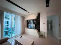 1 Bedroom Condo for Sale at City Center Residence living space with modern TV unit and balcony access