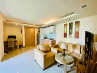 1 Bedroom Condo for Sale at City Garden Pattaya open-plan living room with kitchenette and study desk
