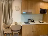 Studio Condo for Sale at City Garden Pratumnak kitchenette with stove, sink, microwave, and dining nook