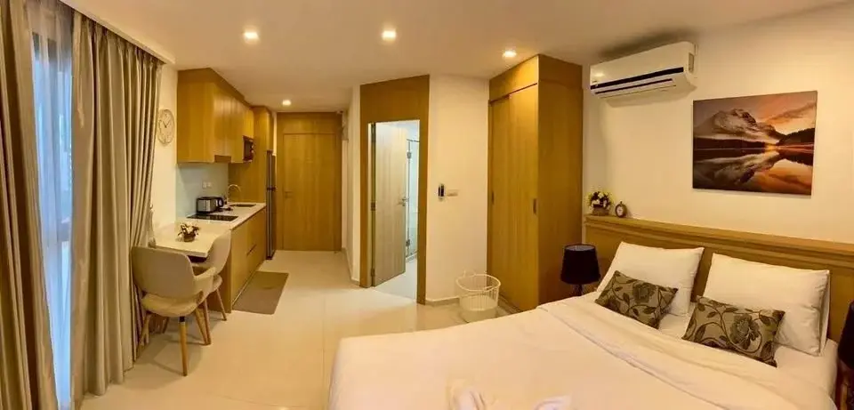 Studio Condo for Sale at City Garden Pratumnak panoramic view of bedroom, kitchen, and bathroom entrance
