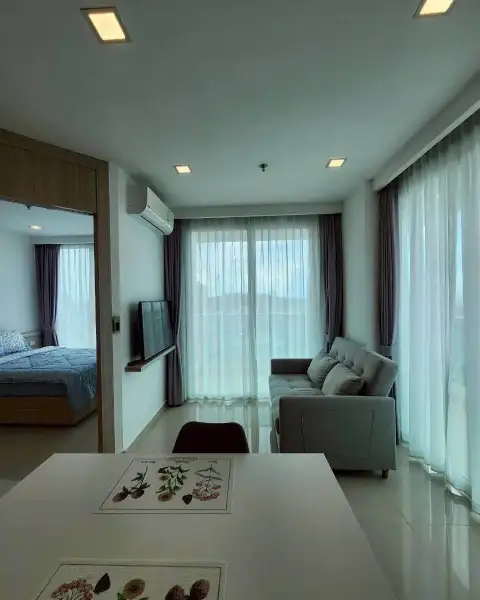 1 Bedroom Condo for Rent at City Garden Tower living room with sofa, TV and view into bedroom