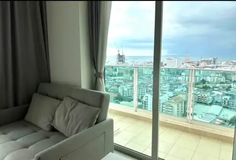 1 Bedroom Condo for Rent at City Garden Tower balcony view of Pattaya city and sea from sofa seating area