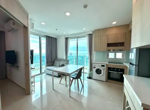 1 Bedroom Condo for Rent at City Garden Tower living room with dining table, sofa and kitchen overlooking Pattaya skyline