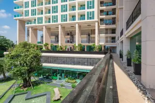 City Garden Tower outdoor swimming pool with sun loungers and a modern building facade in the background.