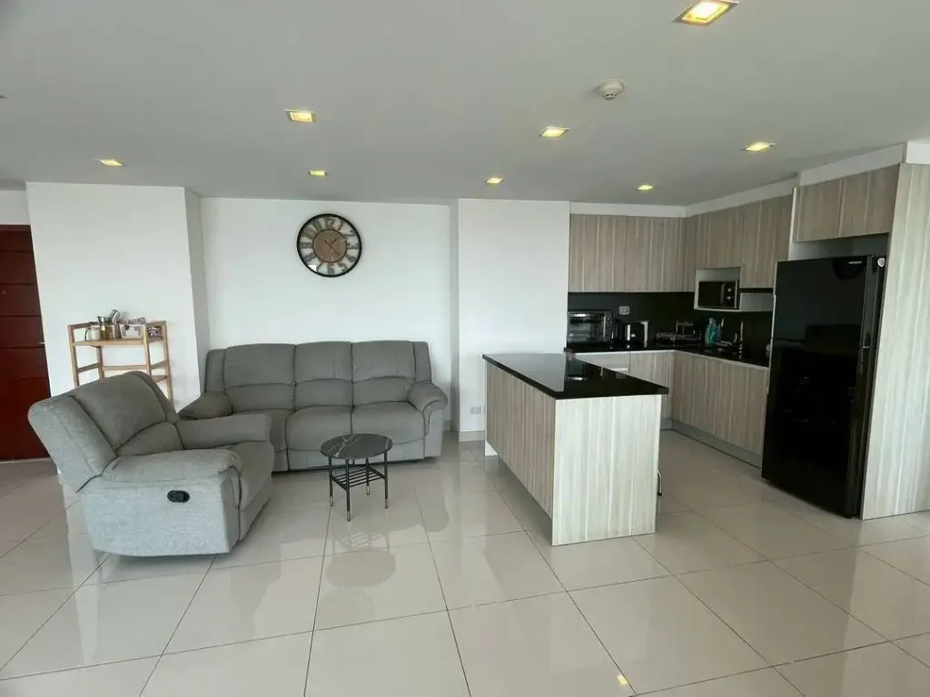 2 Bedroom Condo for Sale at Club Royal open-plan living room with gray sofas and modern kitchen island