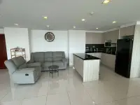 2 Bedroom Condo for Sale at Club Royal open-plan living room with gray sofas and modern kitchen island
