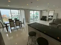 2 Bedroom Condo for Sale at Club Royal dining table and kitchen bar with sea view through balcony windows