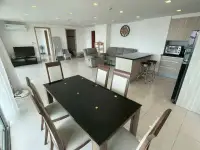 2 Bedroom Condo for Sale at Club Royal wide view of living room, dining table, and kitchen with sea view