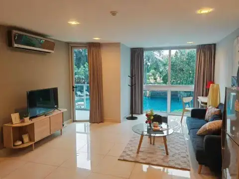 1 Bedroom Condo for Rent at Club Royal lounge area with TV console, balcony door and pool view