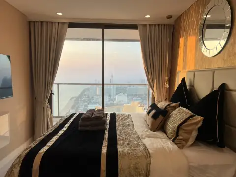 1 Bedroom Condo for Rent at Copacabana Beach Jomtien bedroom with floor-to-ceiling window overlooking Pattaya