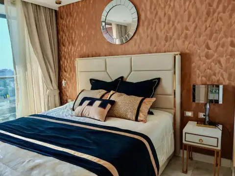 1 Bedroom Condo for Rent at Copacabana Beach Jomtien bedroom with balcony window showing Jomtien sea and city skyline