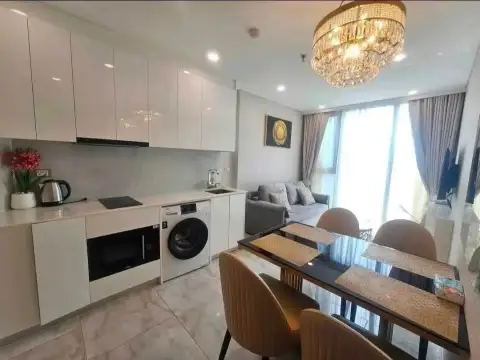 1 Bedroom Condo for Rent at Copacabana Beach Jomtien kitchenette with white cabinets and dining table view