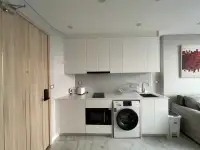 1 Bedroom Condo for Rent at Copacabana Beach Jomtien compact kitchen with built-in cabinets and appliances